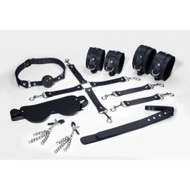Набір Feral Feelings BDSM Kit 7 Black, наручники, поножі, конектор, маска, паддл, кляп, затискачі - 1